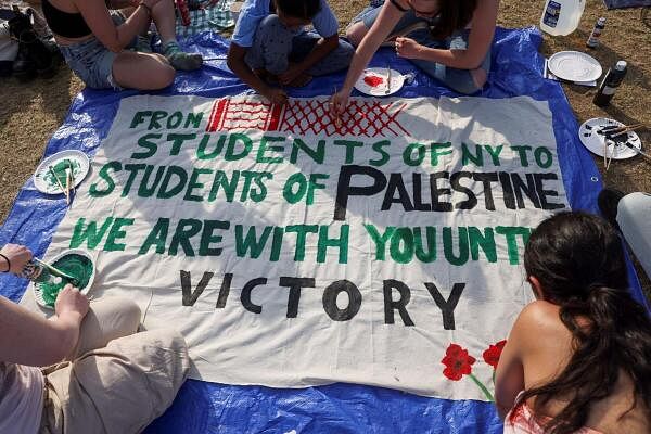 Students at Columbia University paint a response to a message written by Palestinians in Rafah thanking students for their support as they continue to maintain a protest encampment on campus in support of Palestinians, during the Israel's ongoing war on Gaza, in New York City, US.