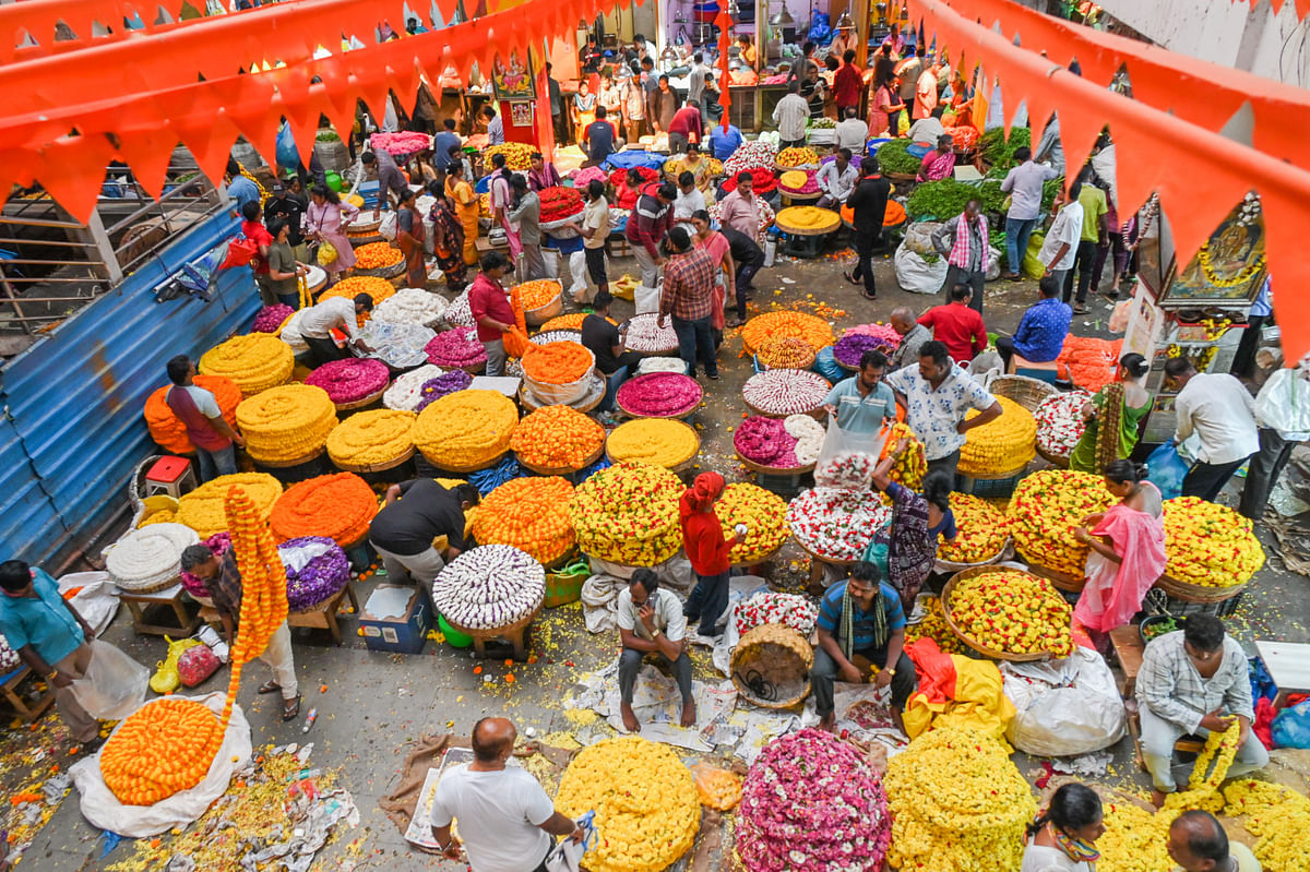 People purchase different verity of colour flowers on the eve of Ugadi festival at K R Market in Bengaluru on Monday.