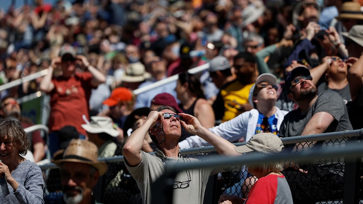 People look to the sky at Saluki Stadium, ahead of a total solar eclipse, where the moon will blot out the sun, in Carbondale, Illinois, US.