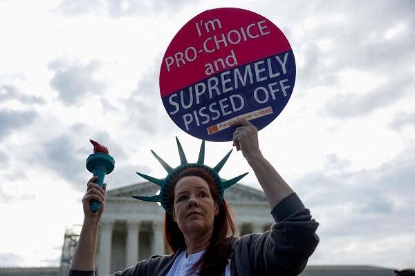 Laurie Woodward Garcia from Tampa, Florida, holds a placard during a "die-in" protest in support of reproductive rights and emergency abortion care, as Supreme Court justices hear oral arguments over the legality of Idaho's Republican-backed, near-total abortion ban in medical-emergency situations, in Washington, U.S