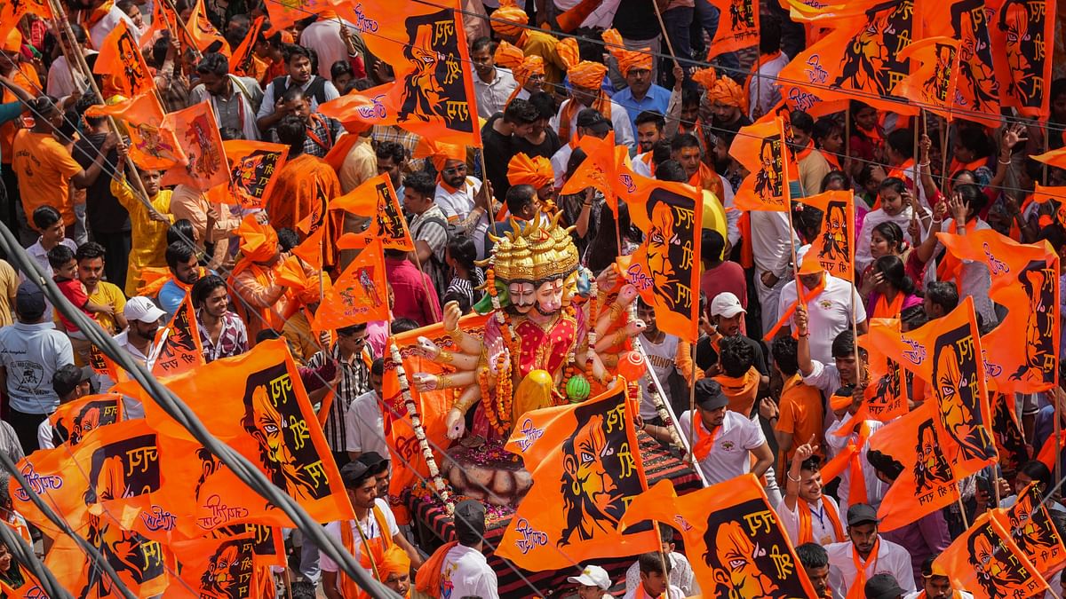 Devotees participate in a religious procession on the occasion of 'Hanuman Jayanti', at Jahangirpuri in New Delhi.