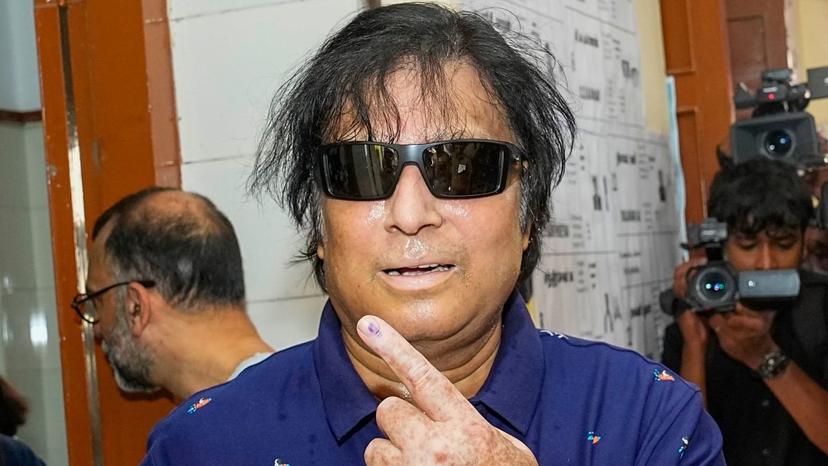 Actor Karthik shows his ink-marked finger as he leaves after casting his vote for the first phase of Lok Sabha elections, at a polling station in Chennai.