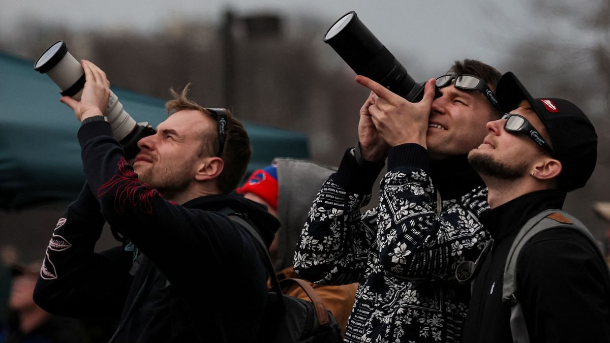 People assemble to view a total solar eclipse, where the moon will blot out the sun, during totality at Niagara Falls, New York.