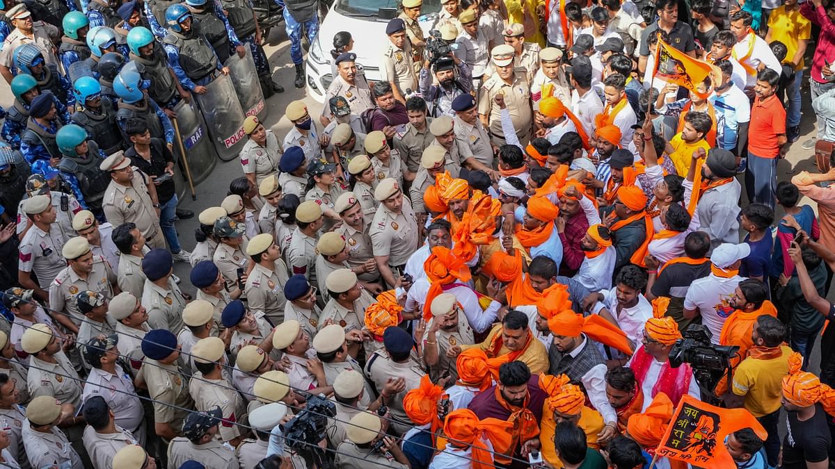 Security personnel attempt to confine devotees participating in a 'Hanuman Jayanti' procession to a limited area, at Jahangirpuri in New Delhi.