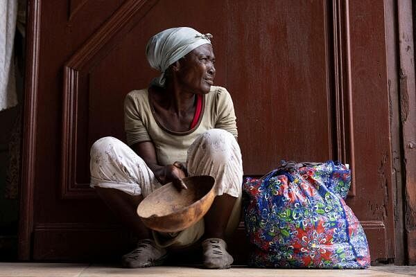 A woman begs for money at the entrance of the Our Lady of the Assumption Cathedral during Sunday mass in Cap-Haitien, Haiti April 28, 2024.