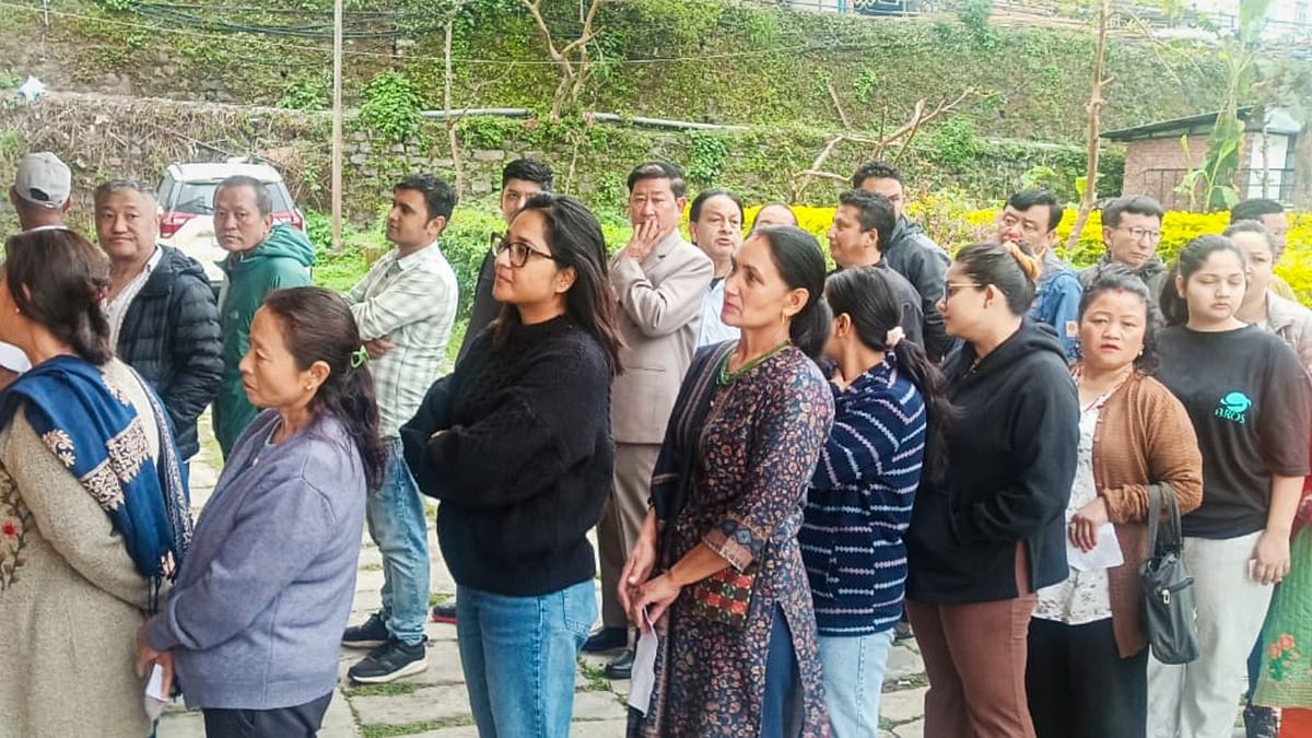 People wait to cast their vote for Lok Sabha elections, at Gyalshing Bazer in Sikkim.
