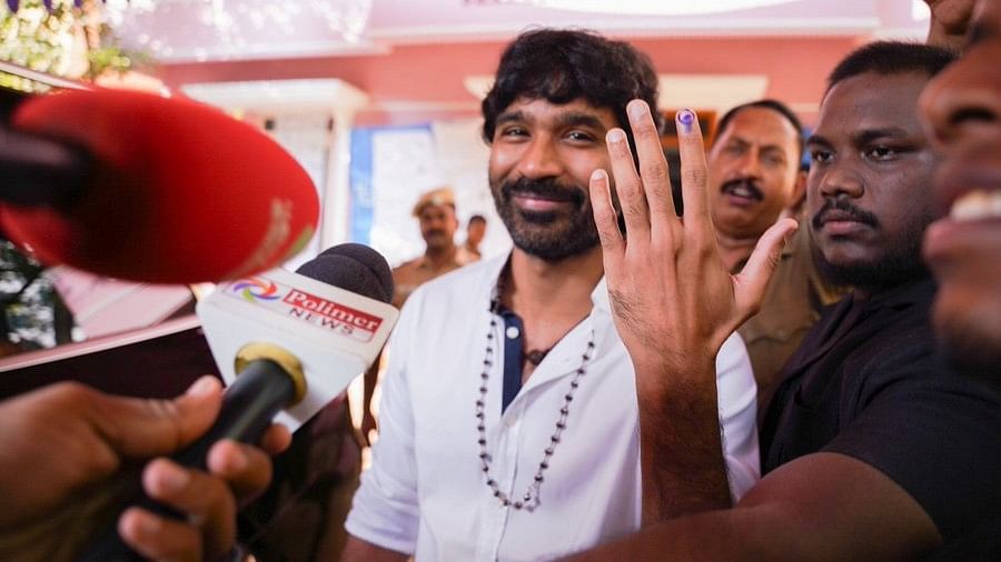 Raayan star Dhanush shows his ink-marked finger after casting his vote for the first phase of Lok Sabha elections, at a polling station in Chennai.