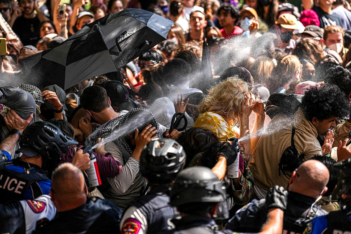 A state trooper pepper sprays pro-Palestinian protesters, during the ongoing conflict between Israel and the Palestinian Islamist group Hamas, after police vehicles were blocked at the University of Texas in Austin, Texas, U.S. April 29, 2024.