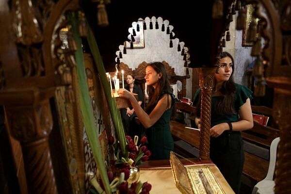 Women stand as Palestinian Christians hold Palm Sunday Mass at the Greek Orthodox Saint Porphyrius Church, amid the ongoing conflict between Israel and Hamas, in Gaza City April 28, 2024.