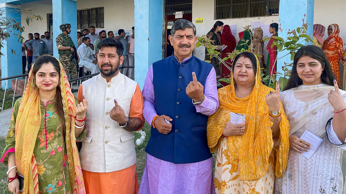 BJP candidate Jugal Kishore Sharma along with his family after exercising their vote at a polling station in the second phase of Lok Sabha elections, in Jammu.