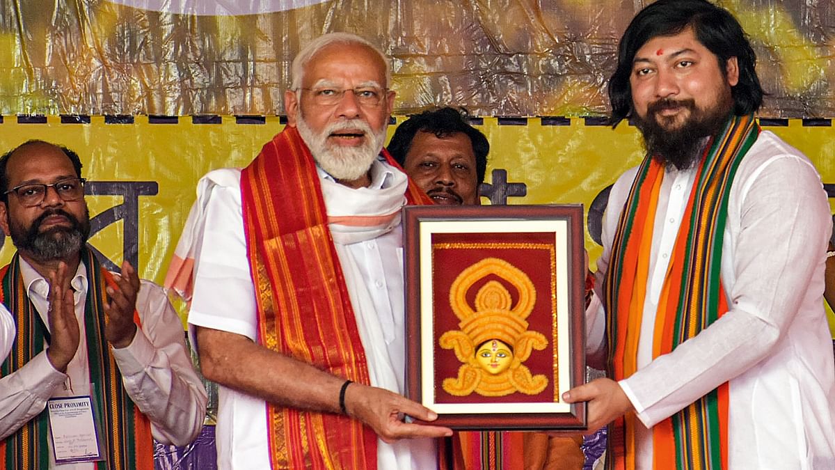 PM Modi was felicitated with a memento by Union Minister and BJP candidate Nisith Pramanik at the rally.