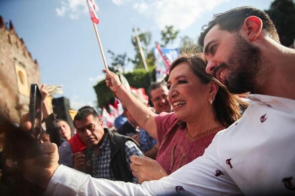 Xochitl Galvez, presidential candidate of the 'Fuerza y Corazon por Mexico', alliance of opposition parties, poses for a selfie with a supporter during a campaign rally, in Tlanepantla, State of Mexico, Mexico