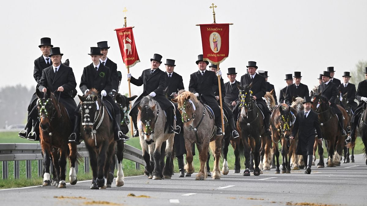 Men of the Slavic ethnic minority of Sorbs, dressed in black tailcoats, ride decorated horses during an Easter rider procession near Ralbitz, eastern Germany.