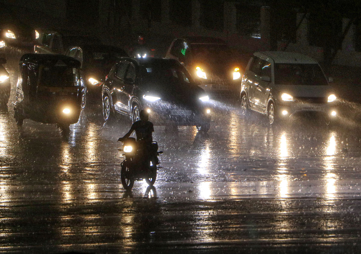 Vehicles ply during heavy rains, in Nagpur, Tuesday.