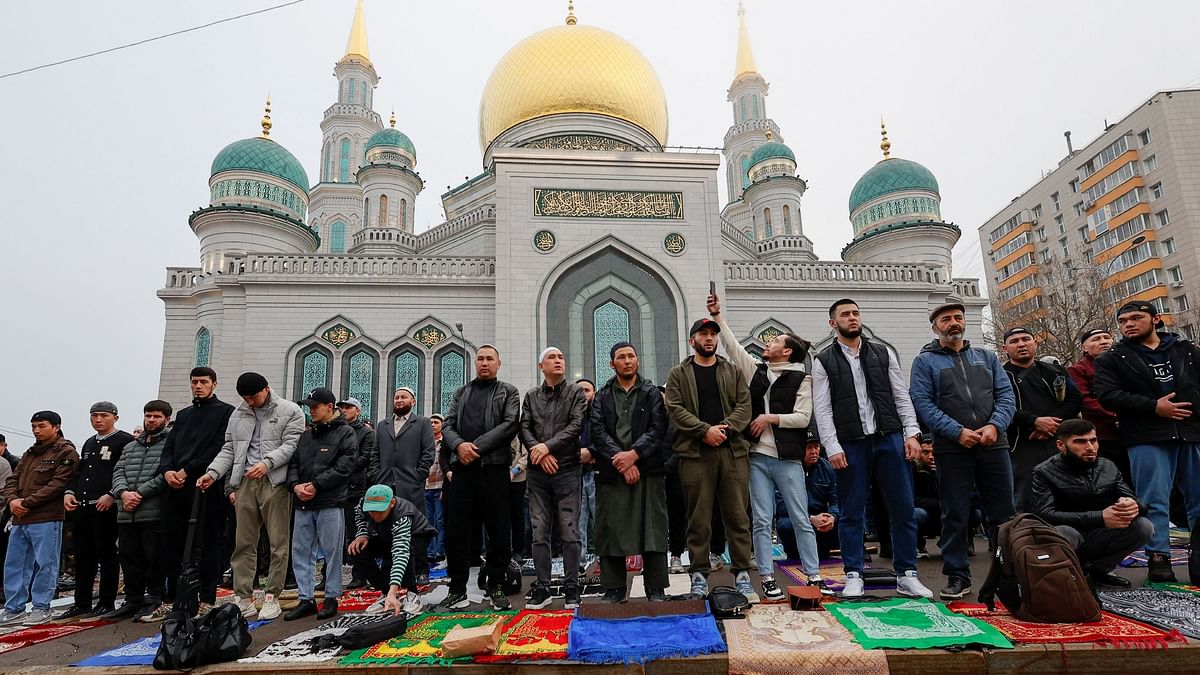 Muslims attend the morning prayers of Eid al-Fitr, marking the end of the holy month of Ramadan, near the Cathedral Mosque in Moscow, Russia.