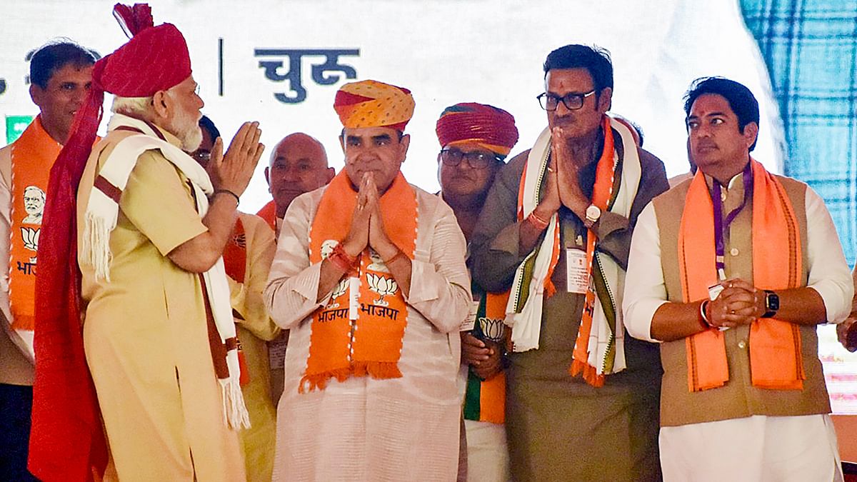PM Modi greets the BJP leaders as he arrives on the stage during a public rally, in Churu, Rajasthan