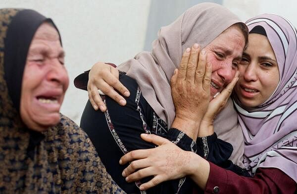 Women mourn near the bodies of Palestinians killed in Israeli strikes, amid the ongoing conflict between Israel and the Palestinian Islamist group Hamas, in Rafah, in the southern Gaza Strip.