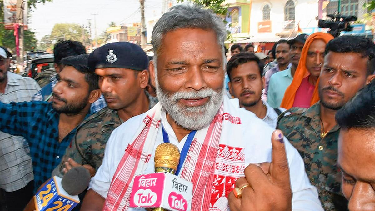 Independent candidate Pappu Yadav shows his finger marked with indelible ink after casting his vote in the second phase of Lok Sabha elections, in Purnea.