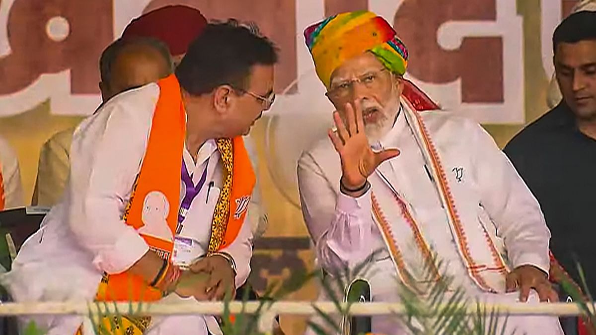 Prime Minister Narendra Modi is seen talking to Rajasthan Chief Minister Bhajanlal Sharma during a rally in Rajasthan.