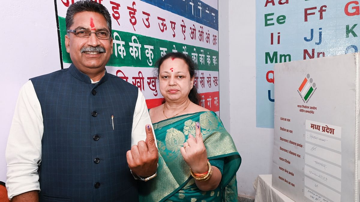 BJP candidate Ashish Dubey and his wife show their fingers marked with indelible ink after casting their vote for the first phase of Lok Sabha elections, in Jabalpur.