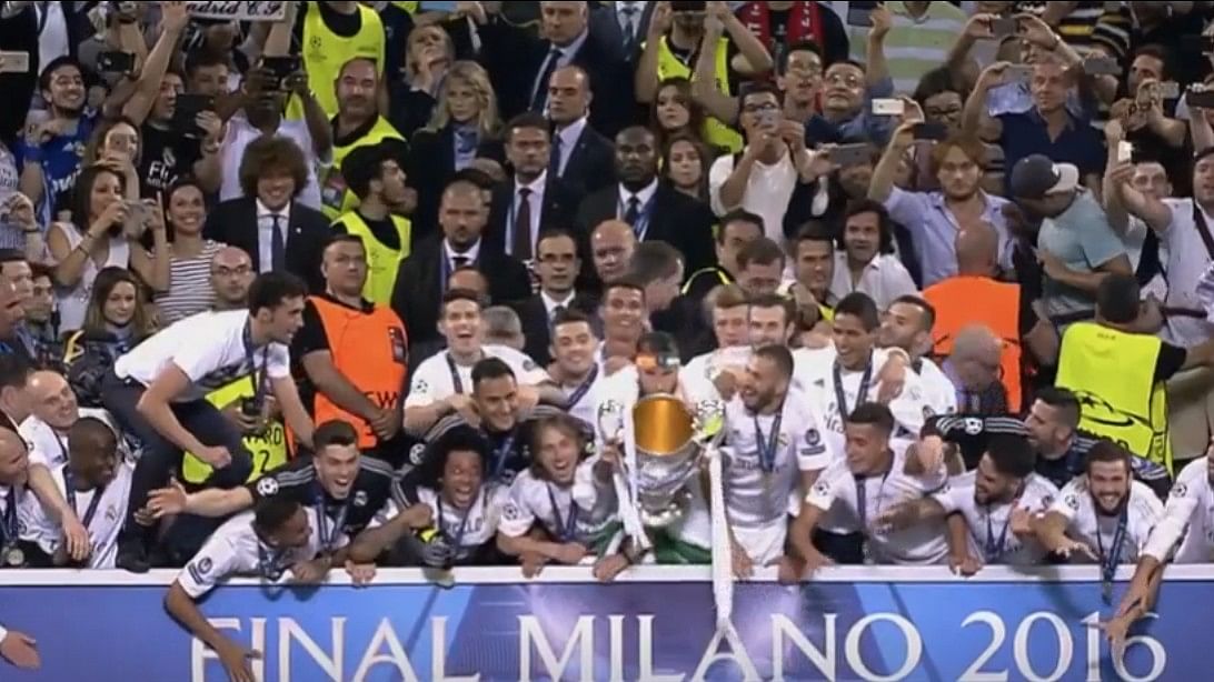 Real Madrid players lifting the 2015-16 UCL trophy.