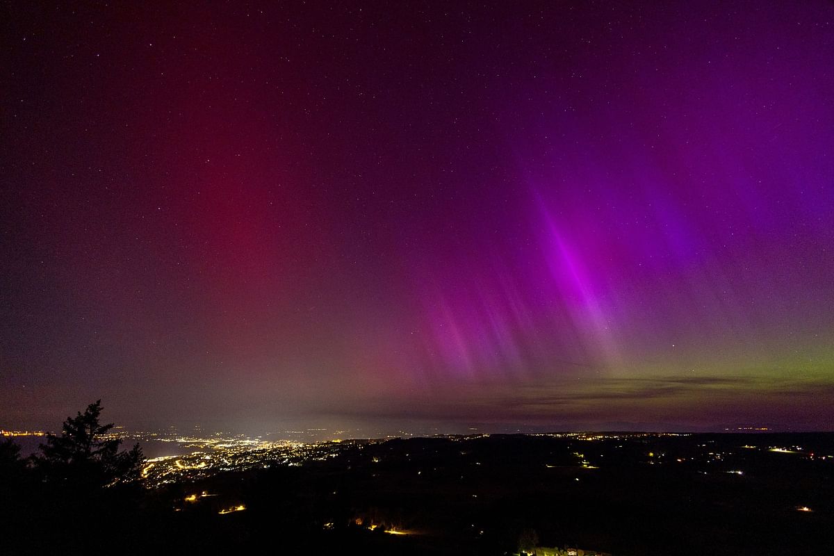 An aurora borealis is seen above Lausanne and the Jura from the Tour de Gourze in Riex, Switzerland, May 11, 2024