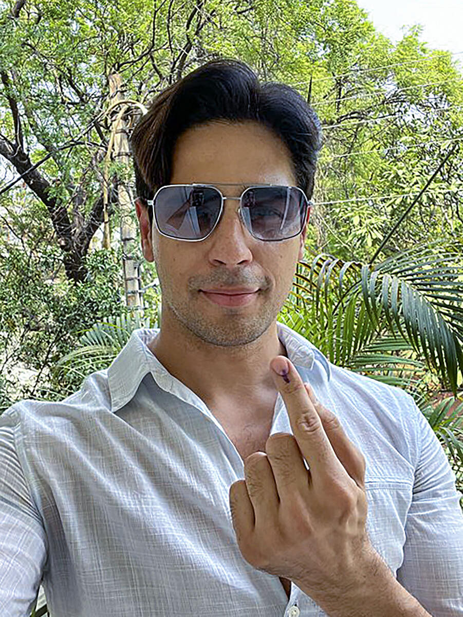 Actor Sidharth Malhotra flashes his ink-marked finger after casting his vote for the 6th phase of Lok Sabha elections, in New Delhi.