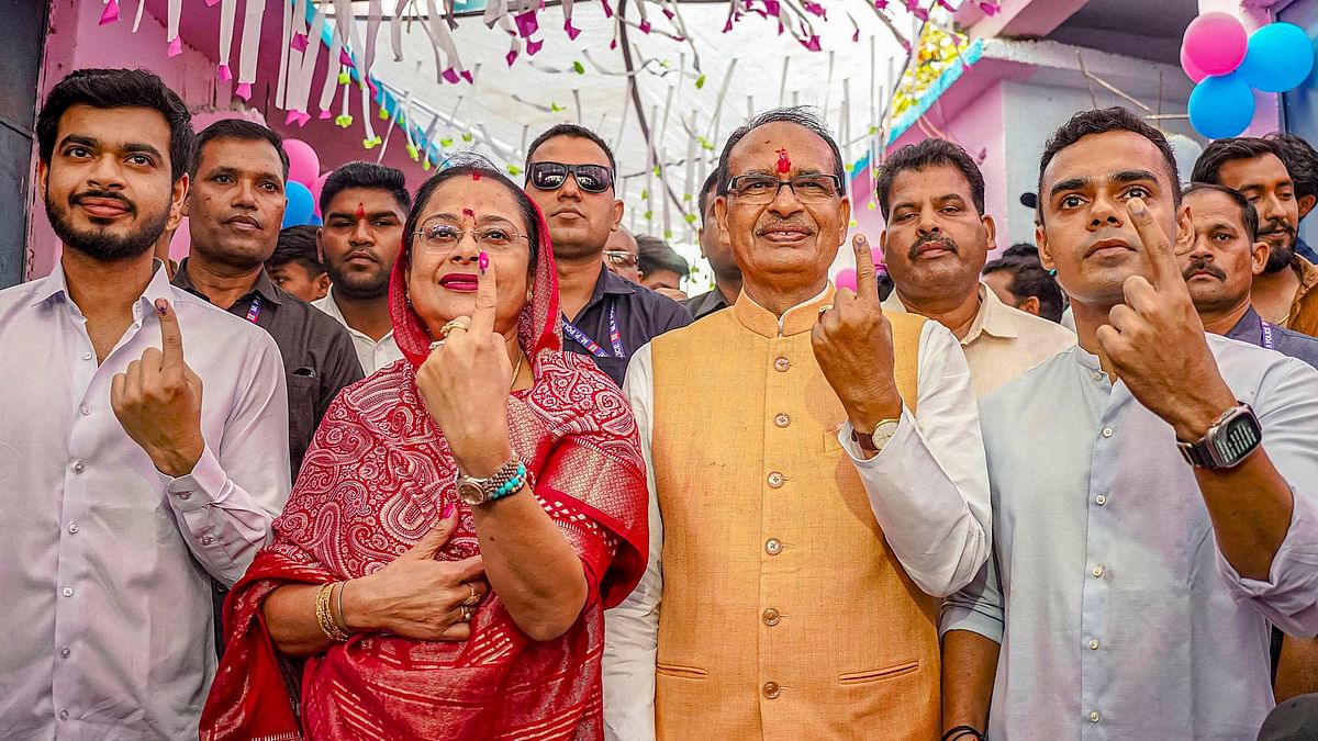 Former Madhya Pradesh Chief Minister Shivraj Singh Chouhan poses with his wife Sadhna Singh and sons Kartikeya Singh Chouhan and Kunal Singh Chouhan after casting their vote at a polling station during the third phase of Lok Sabha elections, in Sehore, MP.