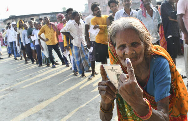 An elderly voter shows her finger marked with indelible ink after casting her vote at a polling booth during the sixth phase of Lok Sabha elections, in Bihar's Muzaffarpur district.