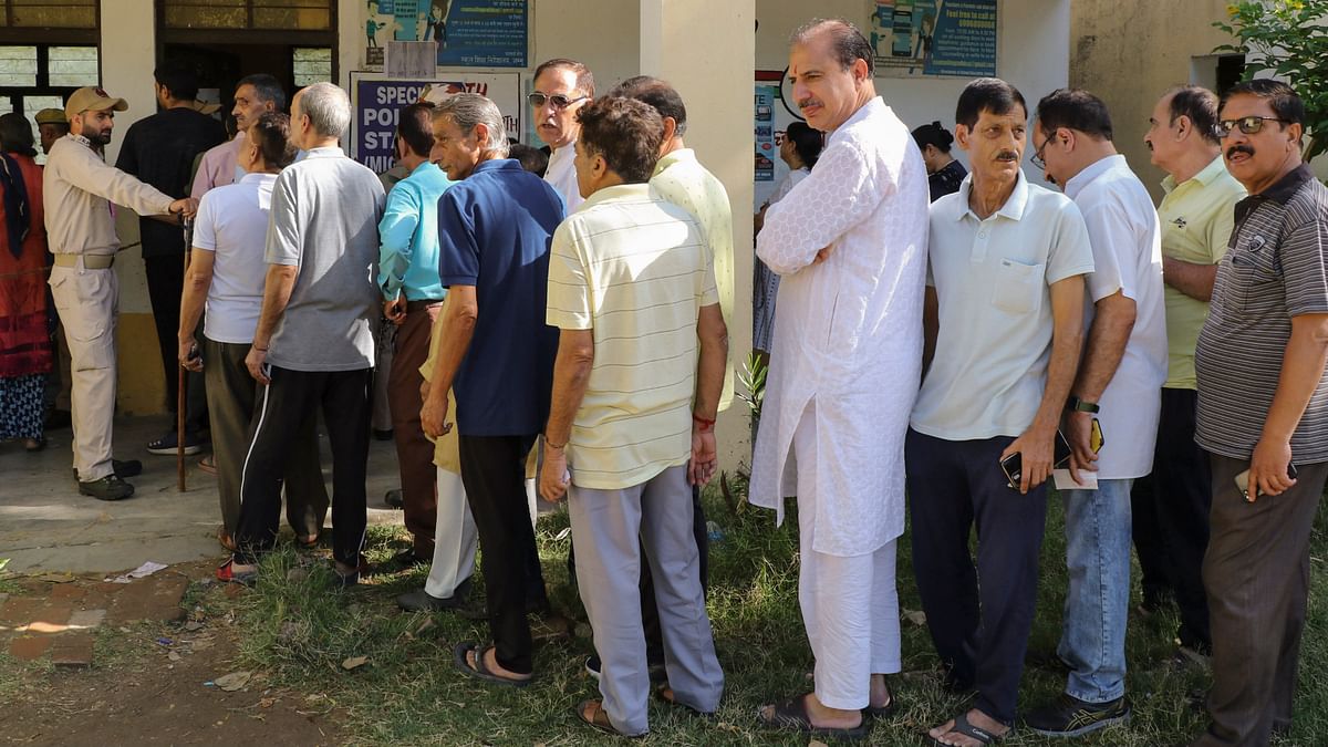Kashmiri Pandits stand in a queue to cast their vote during the fourth phase of Lok Sabha elections, at Roopnagar in Jammu.
