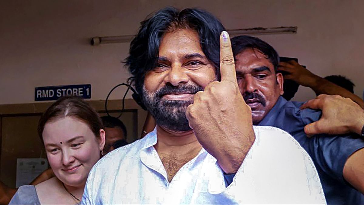 Jana Sena Party President Pawan Kalyan shows his inked finger after casting a vote for Lok Sabha elections, in Mangalagiri, Andhra Pradesh.