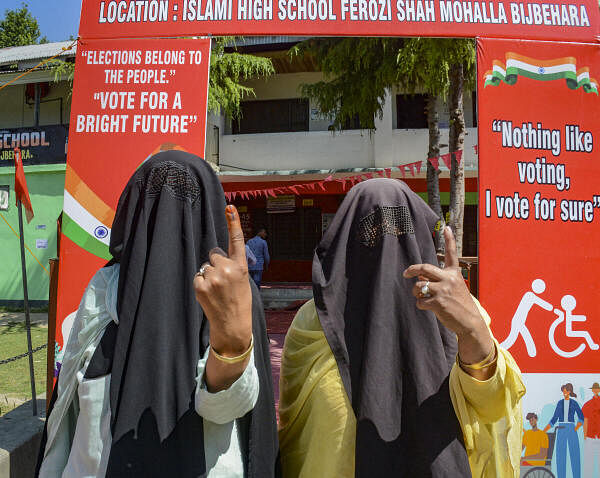 Women show their ink marked fingers after casting votes at a polling station during the sixth phase of Lok Sabha elections, in Anantnag district of south Kashmir.