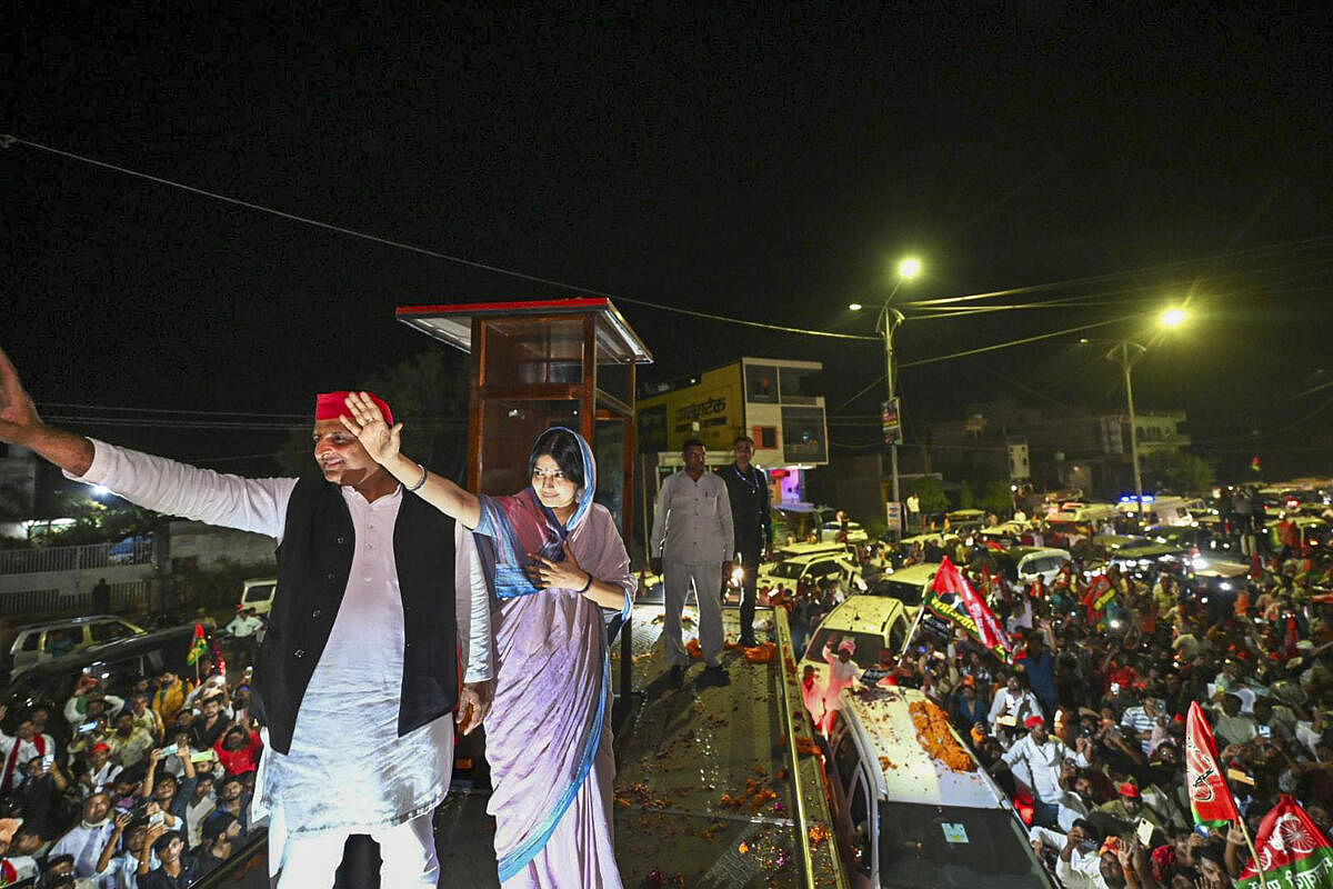 Samajwadi Party President Akhilesh Yadav with Party candidate and his wife Dimple Yadav during a rally for Lok Sabha elections, in Mainpuri.