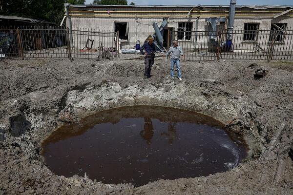 Sergii Polituchyi, Ukrainian publisher and businessman, shows Reuters journalist one of craters next to his printing house, which appeared after a recent Russian missile strike, amid Russia's attack on Ukraine, in Kharkiv, Ukraine May 26, 2024.