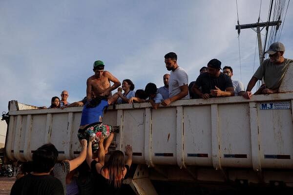 Evacuees get in a truck after their homes were flooded at Eldorado do Sul, in Rio Grande do Sul Brazil.
