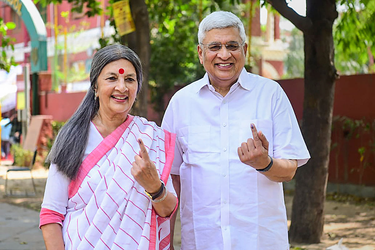 CPI(M) leaders Brinda Karat and Prakash Karat flash their ink-marked fingers after casting votes for the 6th phase of Lok Sabha elections, in New Delhi, om Saturday.