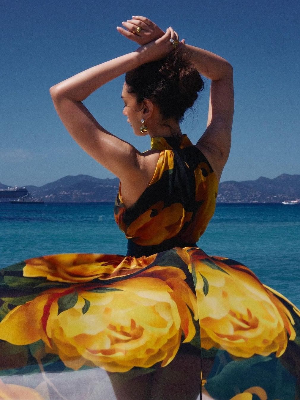 The dress, featured a bold yellow floral prints reminiscing of blooming peonies, exuding a cheerful energy.