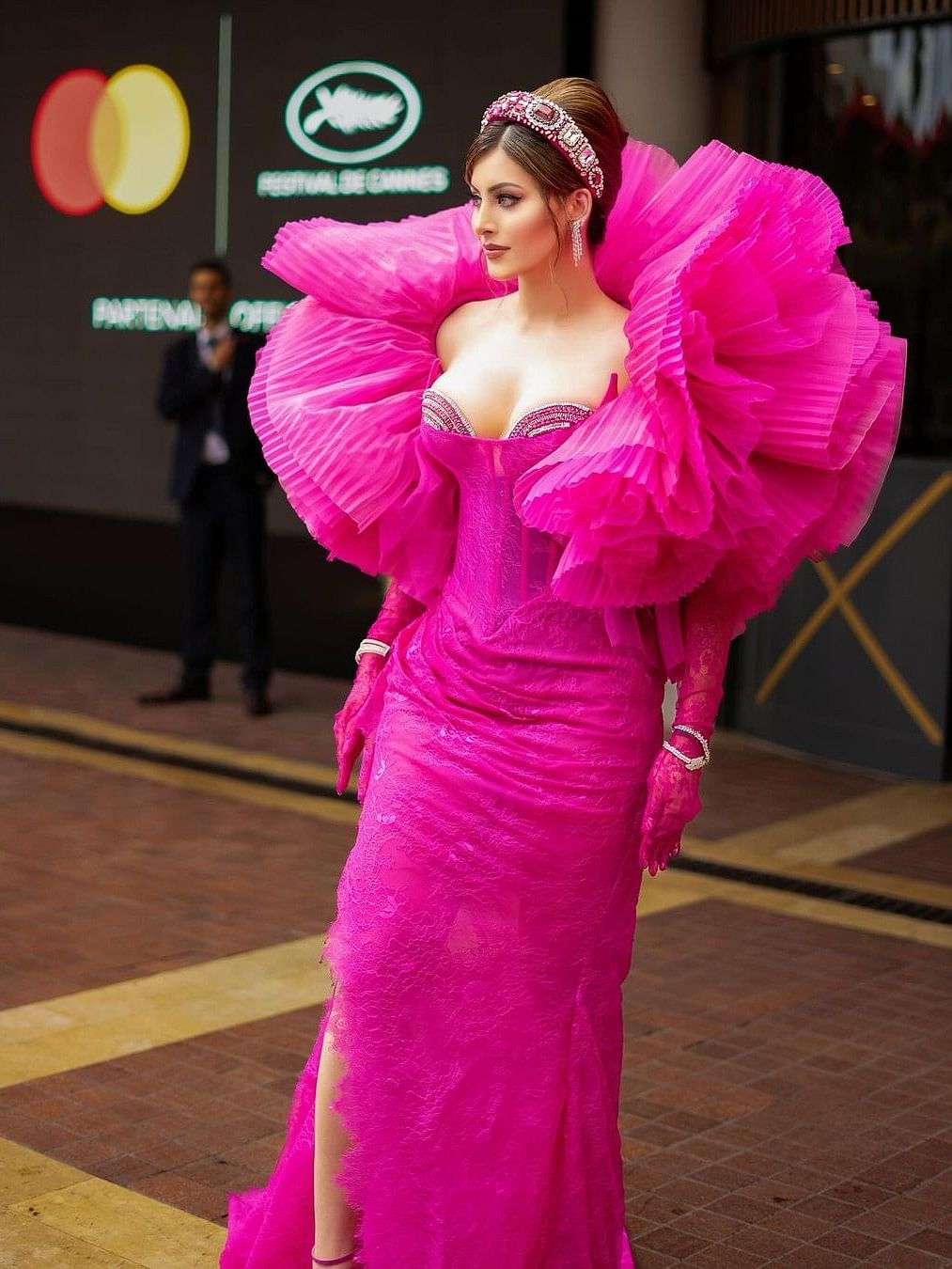 Urvashi's stunning fuschia lace gown featured a corset with a deep neckline embellished with pink and silver crystals for a touch of shimmer. 