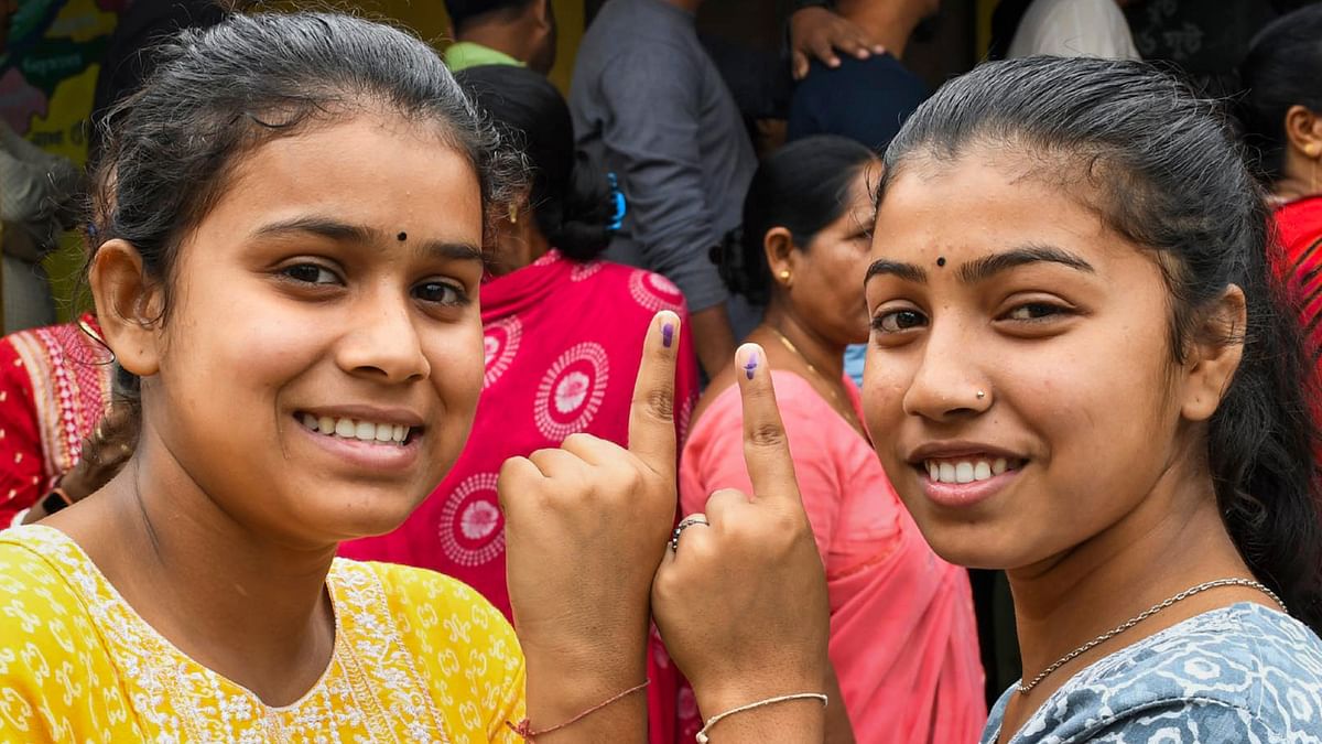 First time voters show their fingers marked with indelible ink after casting vote for the third phase of Lok Sabha elections, in Kamrup, Assam.