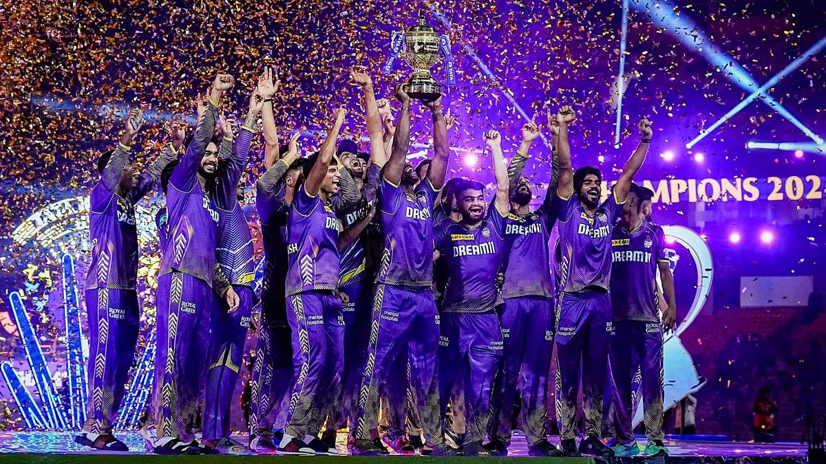 Kolkata Knight Riders players celebrate with the Indian Premier League (IPL) 2024 trophy after winning the final match against Sunrisers Hyderabad at MA Chidambaram Stadium, in Chennai.