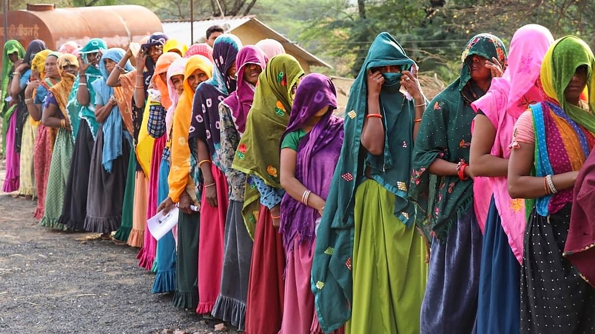 Women wait in a long queue to cast their votes at a polling booth during the fourth phase of Lok Sabha elections in Jhabua district, Madhya Pradesh.