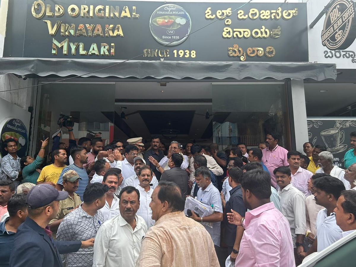 Siddaramaiah outside the Old Original Vinayaka Mylari at Nazarbad in Mysuru where a crowd had gathered to meet him. 