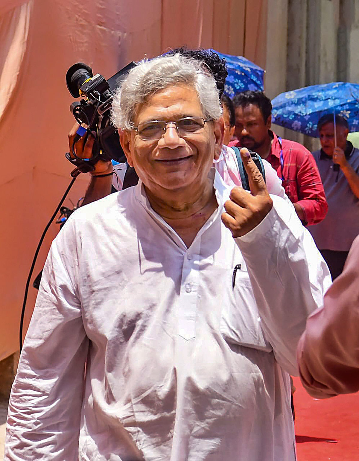 CPI(M) General Secretary Sitaram Yechury flashes his ink-marked finger after casting his vote for the 6th phase of Lok Sabha elections, in New Delhi, on Saturday.