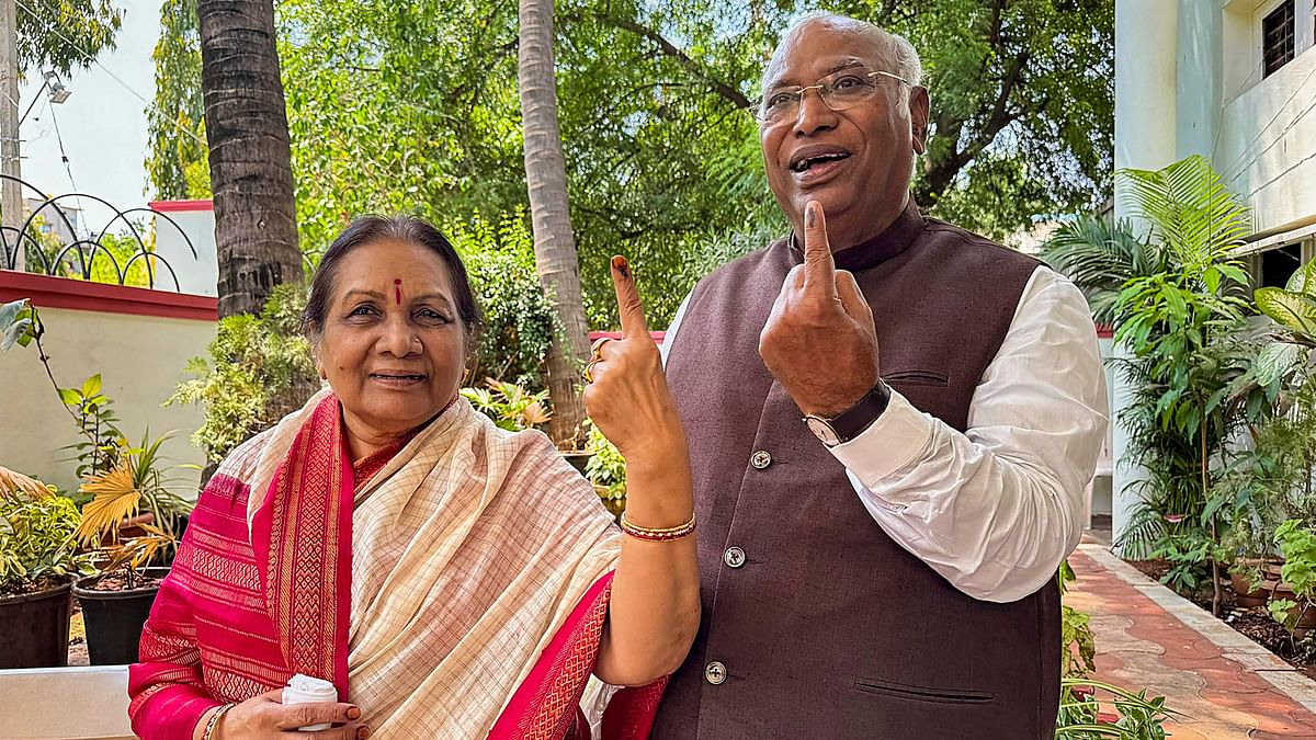 Congress President Mallikarjun Kharge and Radhabai Kharge show their ink-marked finger after casting their vote during the third phase of Lok Sabha elections, in Kalaburagi.