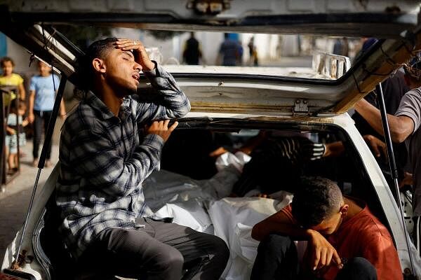 Mourners react next to the bodies of Palestinians killed in an Israeli strike on an area designated for displaced people, during their funeral in Rafah, in the southern Gaza Strip, May 27, 2024.