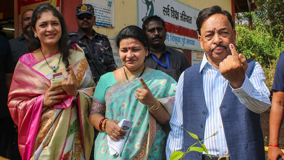 Union Minister Narayan Rane and his family members show their fingers marked with indelible ink after casting their vote for the third phase of Lok Sabha polls, in Ratnagiri, Maharashtra.