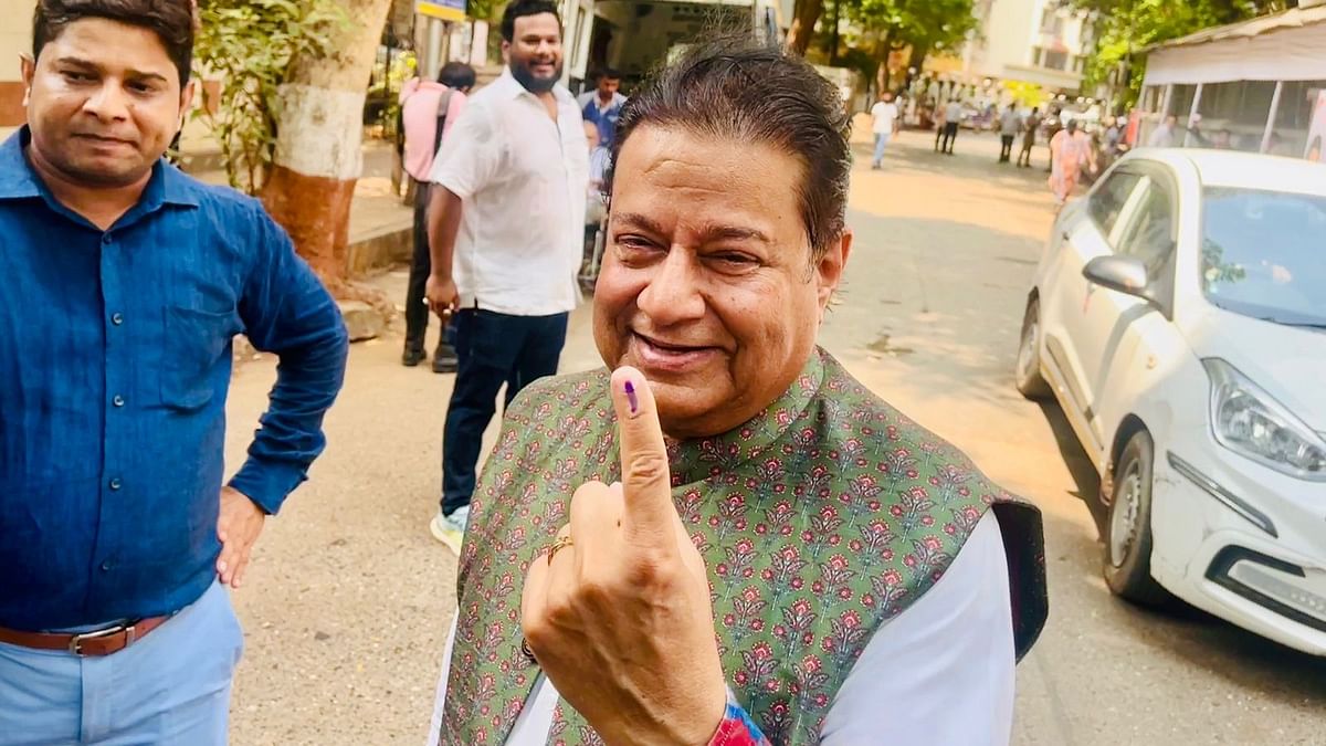 Renowned devotional singer Anup Jalota shows his ink marked finger after casting his vote in Mumbai.