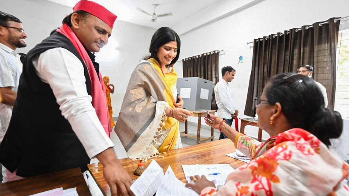 Samajwadi Party Chief Akhilesh Yadav and his wife, party candidate from Mainpuri Dimple Yadav get their fingers marked with indelible ink before casting their vote for the third phase of Lok Sabha polls, in Saifai in Etawah district, Uttar Pradesh.