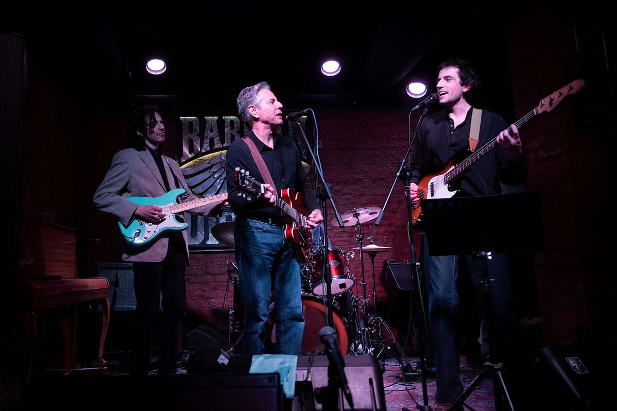 US Secretary of State Antony Blinken performs "Rockin' in the Free World" with members of The 1999 band at the Barman Dictat bar as he visits Kyiv, Ukraine, on May 14.