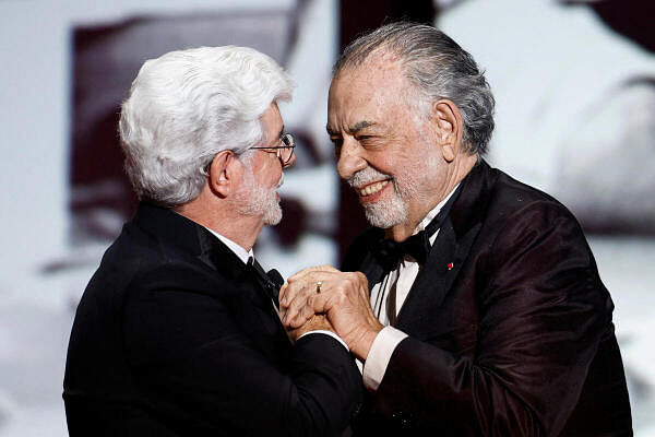 Francis Ford Coppola hugs George Lucas who will receive the Honorary Palme d'Or Award during the closing ceremony of the 77th Cannes Film Festival in Cannes, France, May 25